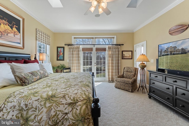 carpeted bedroom with access to exterior, french doors, a skylight, and crown molding