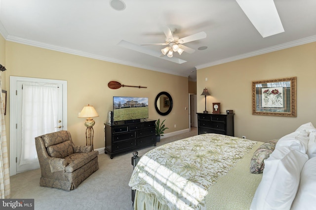 bedroom with crown molding, ceiling fan, baseboards, light carpet, and a skylight