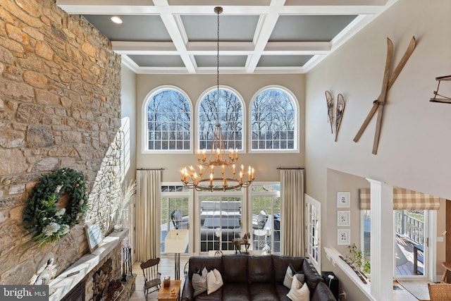 living area featuring a high ceiling, a notable chandelier, beamed ceiling, and coffered ceiling