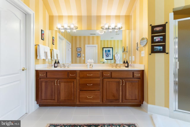 bathroom with wallpapered walls, a shower stall, baseboards, and a sink