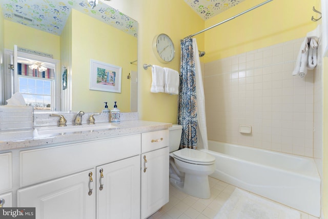 full bath featuring tile patterned flooring, vanity, toilet, and shower / tub combo