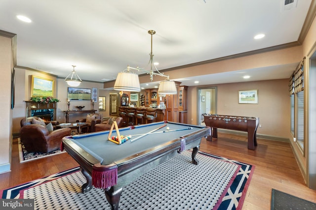 game room featuring recessed lighting, light wood-type flooring, baseboards, and ornamental molding