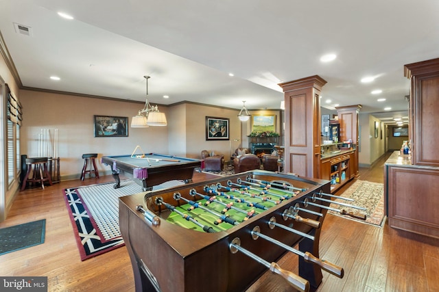 rec room featuring pool table, light wood-type flooring, ornamental molding, decorative columns, and recessed lighting