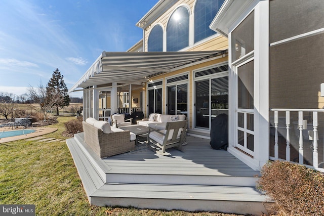 wooden terrace with an outdoor living space, a fenced in pool, and a lawn