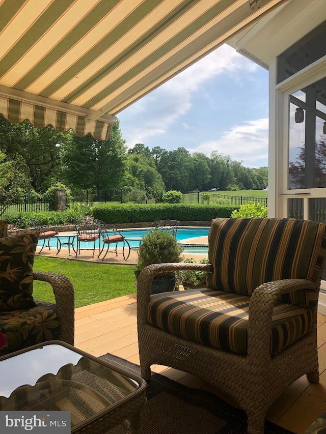 view of patio / terrace with a fenced in pool and fence