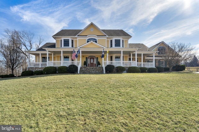 view of front facade with covered porch and a front yard