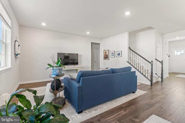 living room featuring dark hardwood / wood-style flooring and a wealth of natural light