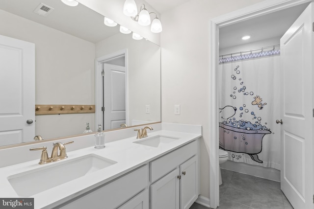 bathroom with a shower with curtain, tile patterned floors, vanity, and toilet