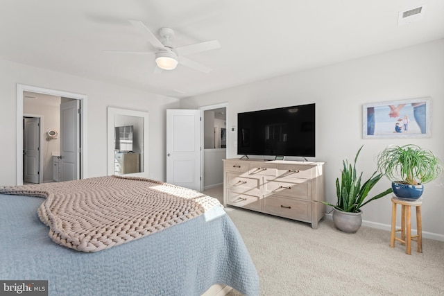 bedroom featuring connected bathroom, light carpet, and ceiling fan