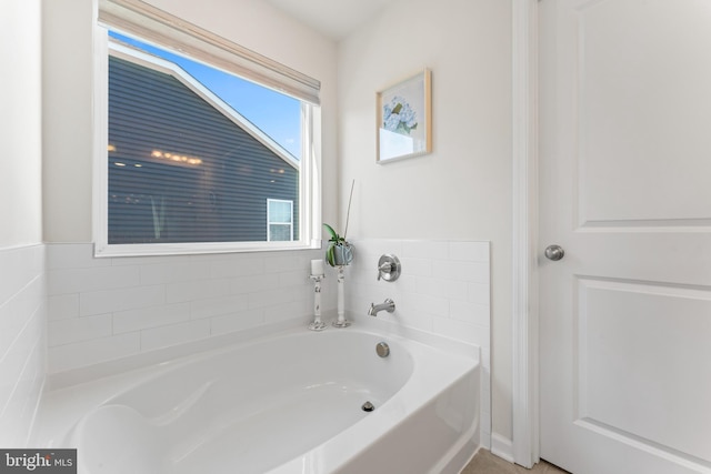 bathroom with a tub to relax in