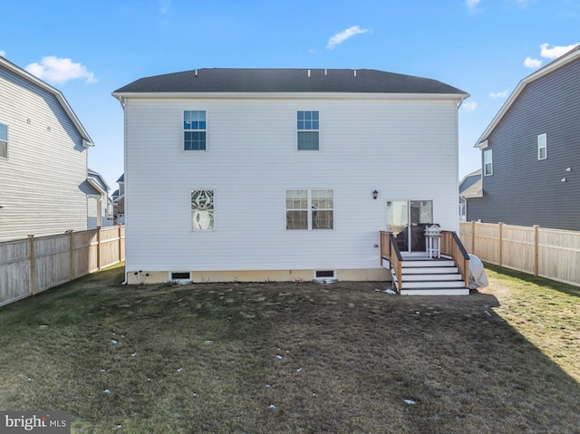 rear view of property featuring a lawn