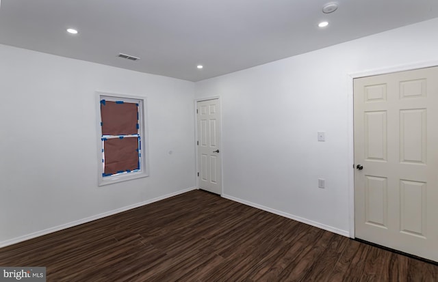 unfurnished room with dark hardwood / wood-style flooring