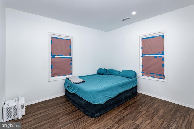 bedroom with dark wood-type flooring