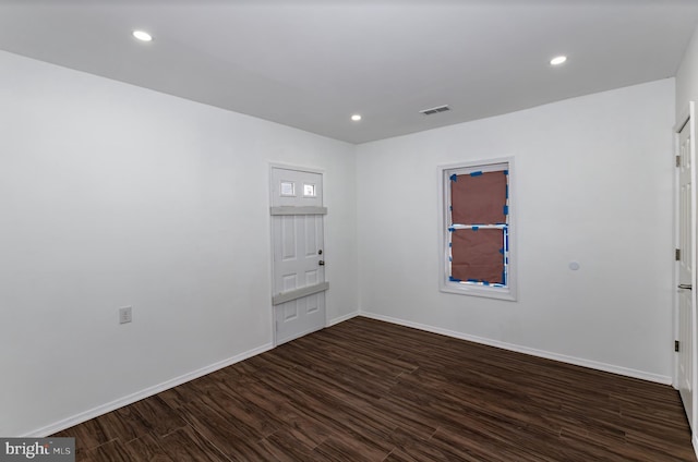 empty room with dark hardwood / wood-style floors