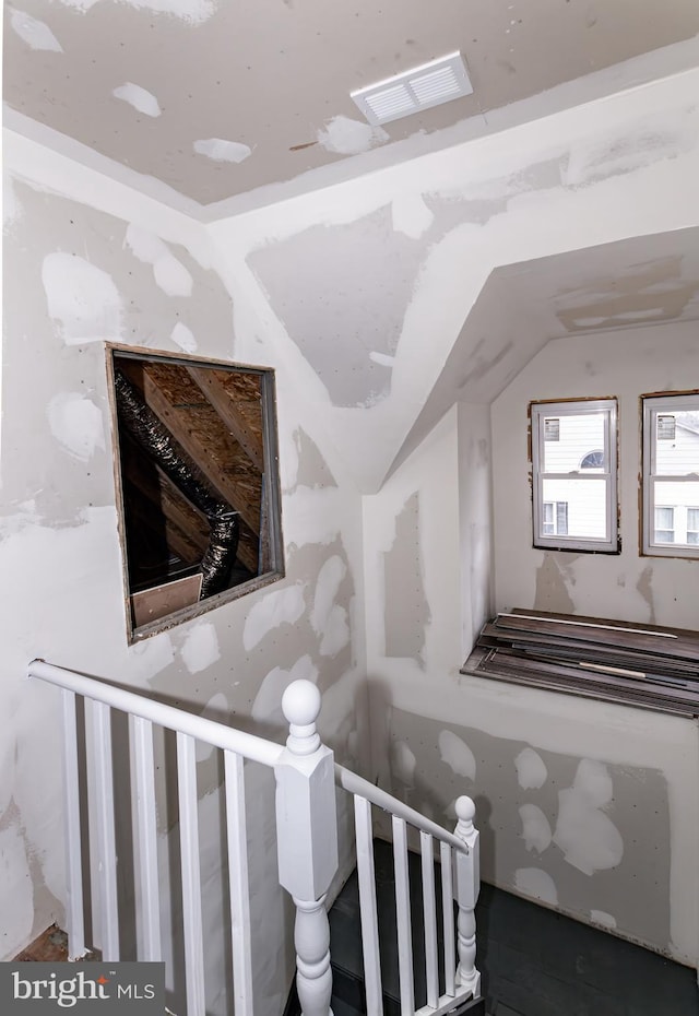 stairway with vaulted ceiling