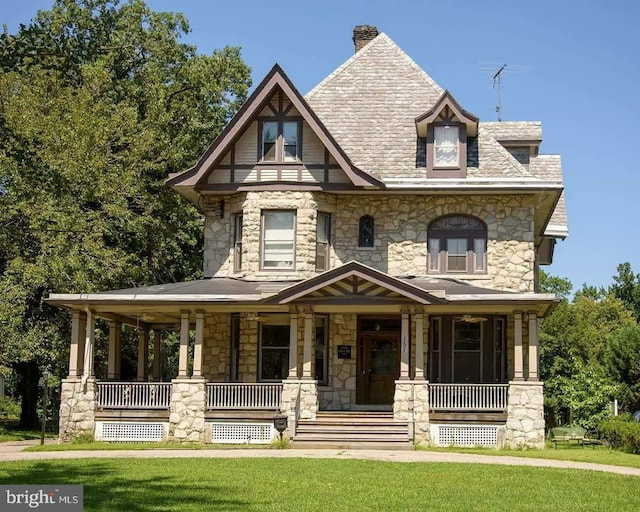 view of front of house with a porch and a front lawn