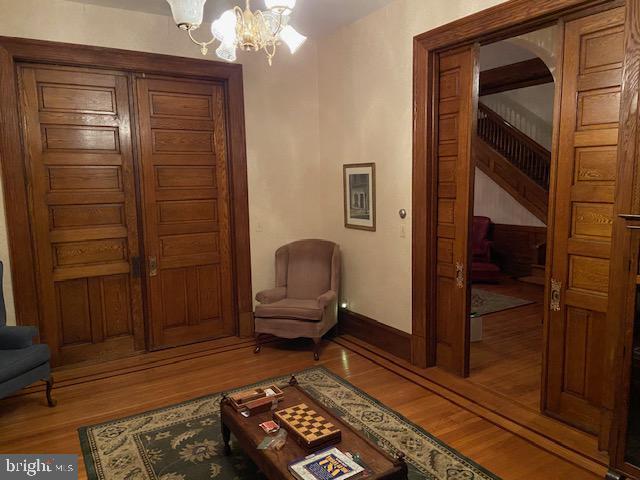 living area featuring light hardwood / wood-style floors and an inviting chandelier