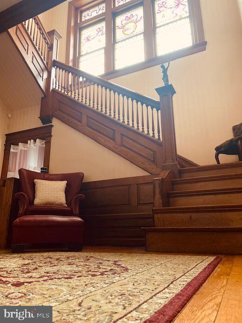 stairway with hardwood / wood-style floors