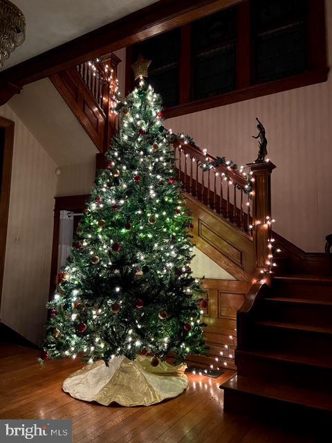 stairs featuring hardwood / wood-style floors