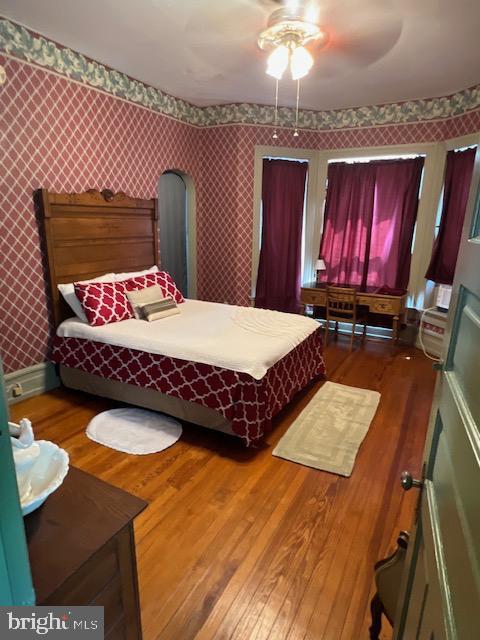 bedroom featuring ceiling fan and dark hardwood / wood-style flooring