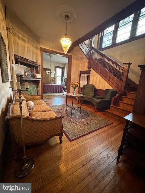 living area featuring hardwood / wood-style floors and a notable chandelier