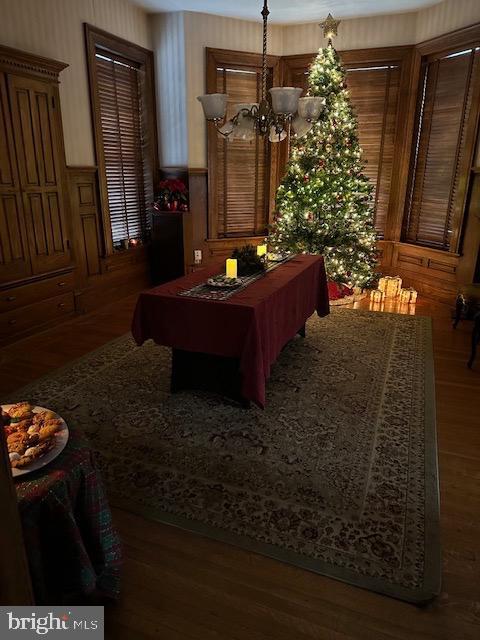 recreation room with a notable chandelier and dark hardwood / wood-style flooring