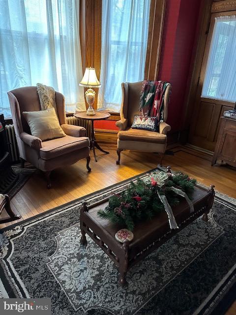 sitting room with hardwood / wood-style floors and plenty of natural light