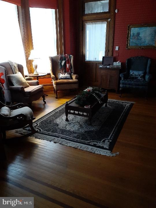 sitting room featuring dark wood-type flooring