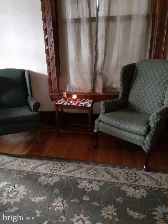 living area with hardwood / wood-style flooring