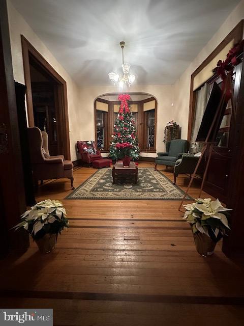 interior space with hardwood / wood-style flooring and an inviting chandelier