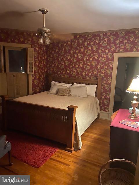 bedroom with wood-type flooring