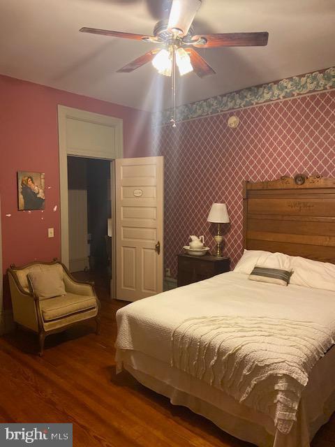 bedroom featuring ceiling fan and wood-type flooring