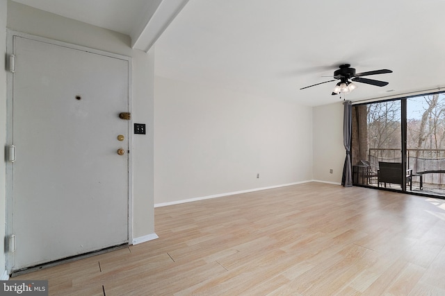 entryway with ceiling fan and light hardwood / wood-style flooring