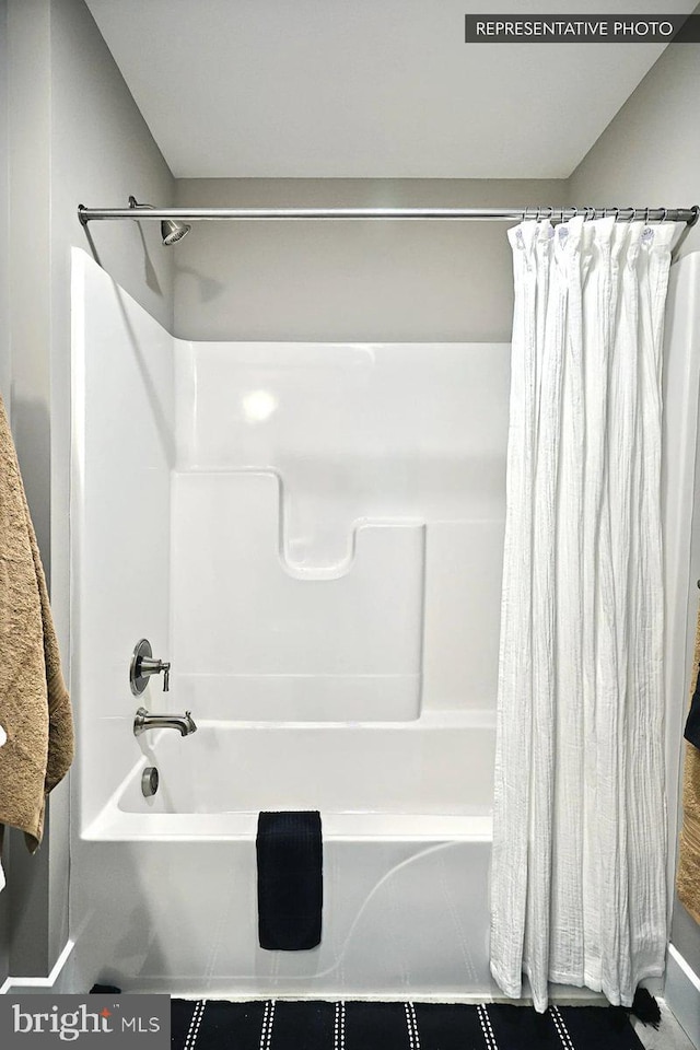 bathroom featuring shower / bath combo and tile patterned floors