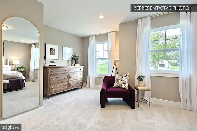 sitting room featuring recessed lighting, light colored carpet, and baseboards