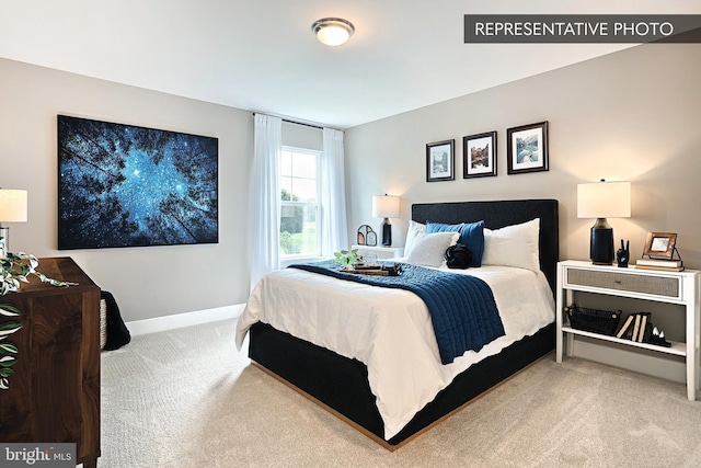 bedroom featuring carpet and baseboards