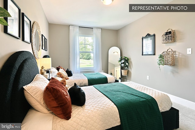 bedroom featuring carpet flooring and baseboards