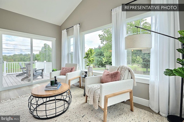 sunroom / solarium featuring vaulted ceiling