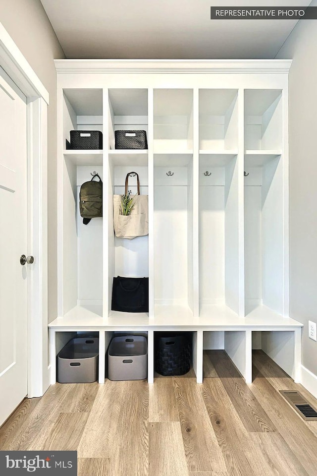 mudroom with visible vents and wood finished floors