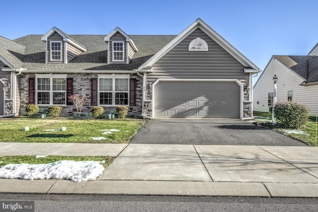 cape cod home with a garage and a front lawn