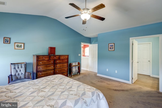 bedroom featuring ceiling fan, light colored carpet, and vaulted ceiling