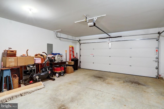 garage featuring electric panel and a garage door opener