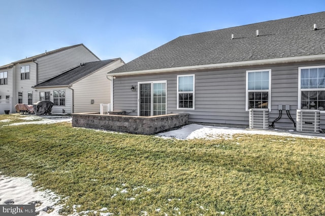 rear view of property with central air condition unit, a patio area, and a lawn