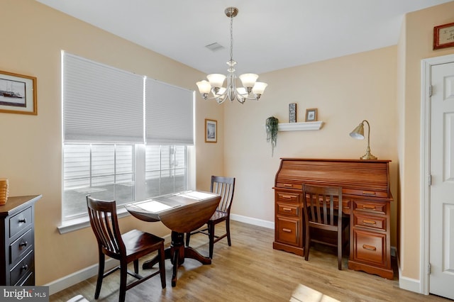 dining room featuring a chandelier and light hardwood / wood-style flooring