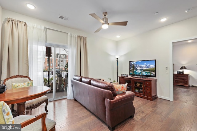 living room with ceiling fan and hardwood / wood-style floors