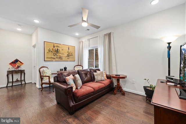 living room with ceiling fan and dark wood-type flooring