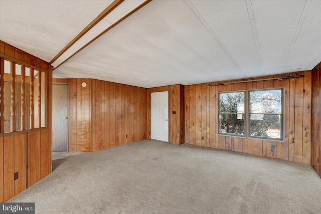 carpeted empty room featuring a textured ceiling