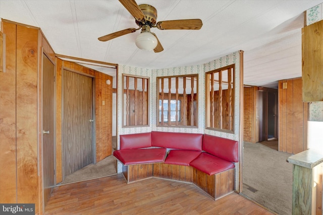 living area featuring ceiling fan and light hardwood / wood-style flooring