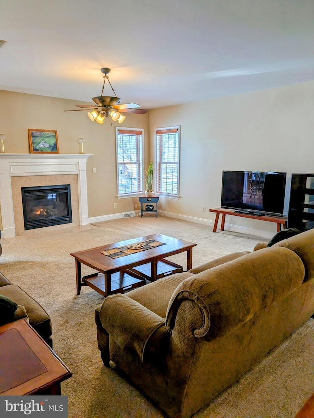 carpeted living room featuring ceiling fan