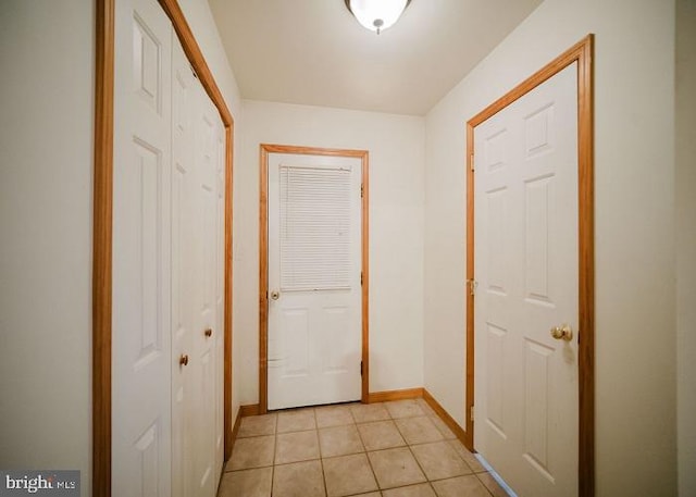 hall featuring light tile patterned floors